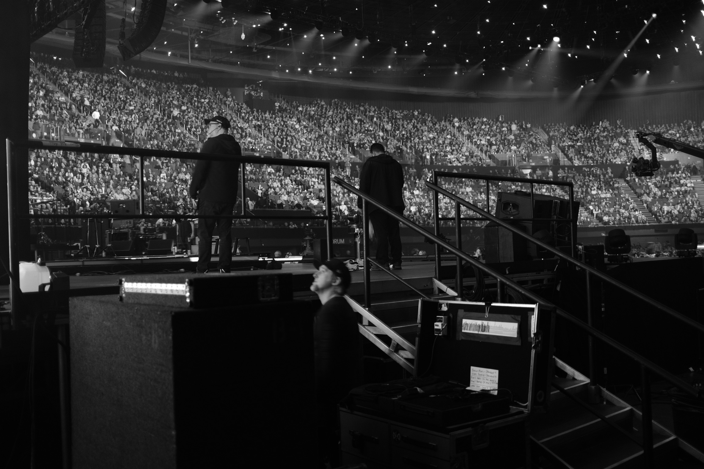 FireAid 2025 — side-of-stage view of the sold-out Kia Forum during the broadcast, RPG road cases in foreground
