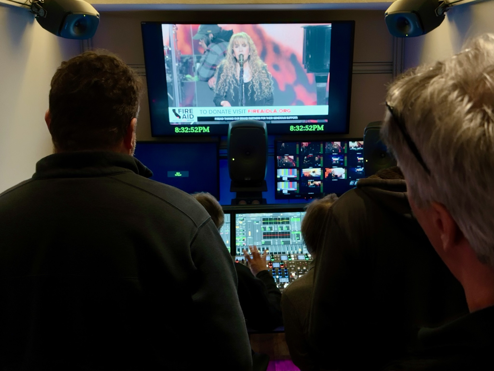 FireAid 2025 — Stevie Nicks performing on the broadcast monitor with the FireAid donate-now graphic, three RPG engineers at the Lawo mc²96 mixing the cut at 8:32 PM